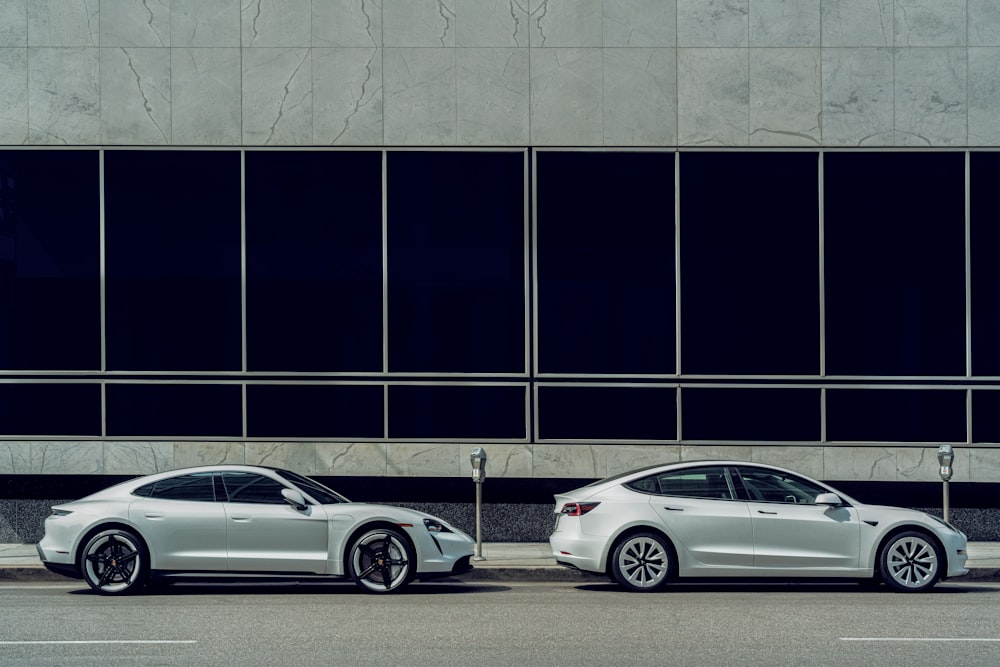 white sedan parked beside white and black building