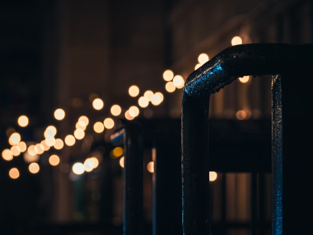 bokeh photography of black metal bar