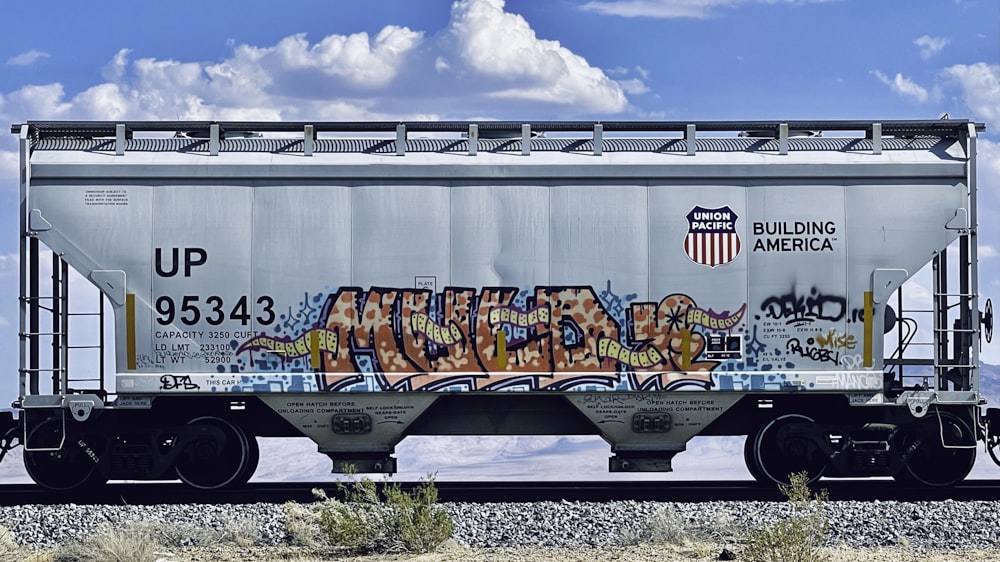 white blue and brown train on rail tracks during daytime