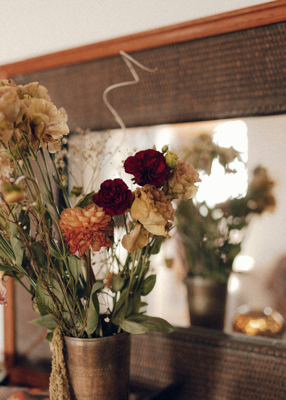 red and yellow flowers in clear glass vase