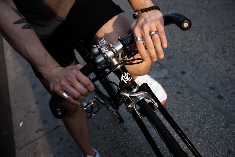 person in black shirt riding on bicycle