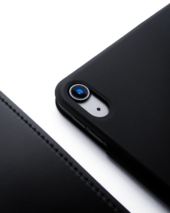 Close-up of a sleek black smartphone case with subtle matte texture and elegant stitching.
