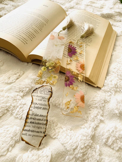 A close-up of colorful 3D printed bookmarks with intricate designs resting on an open book