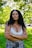 woman in white floral lace brassiere standing on green grass field during daytime