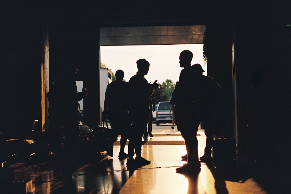 silhouette of people walking on hallway