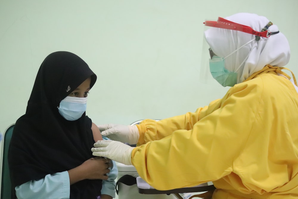 person in white mask and yellow jacket