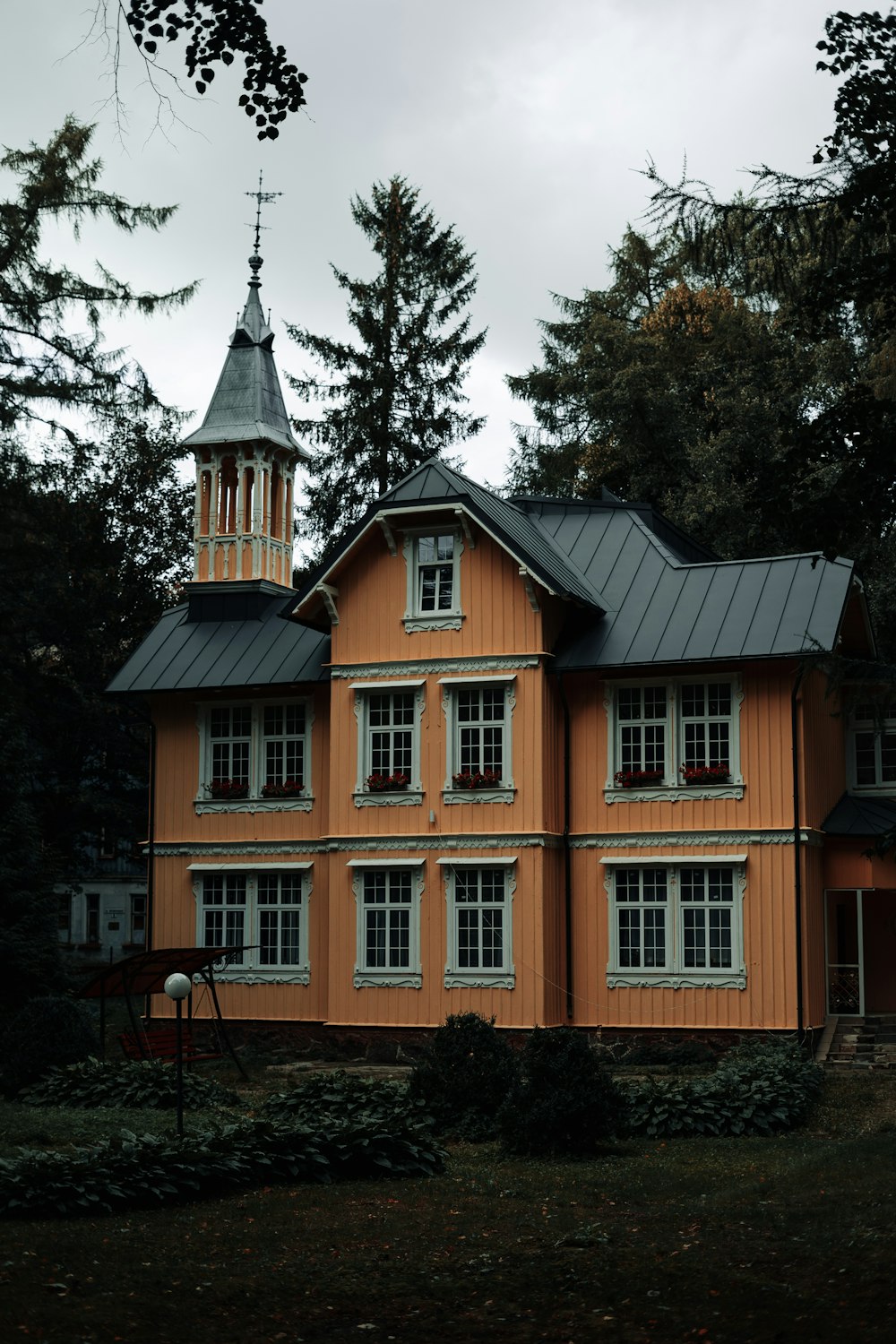 a large orange building with a steeple on top of it