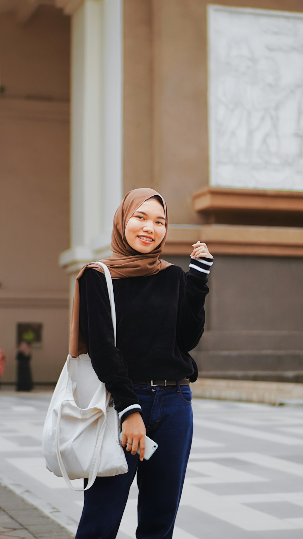 woman in black long sleeve shirt and blue denim jeans