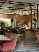 A cozy corner of the restaurant with terracotta red walls and warm lighting.