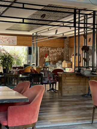 Warm, inviting interior of Pretty Patty with deep forest green walls and burnt orange accents.