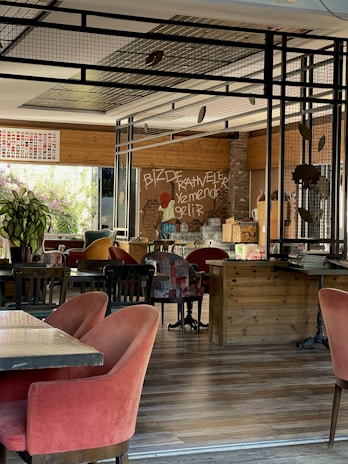 Cozy interior of Food & Bar Altroke with warm brown, white, and beige tones and wooden tables.