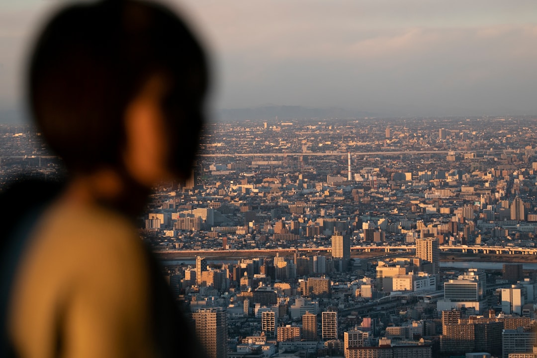 person standing in front of city buildings during daytime