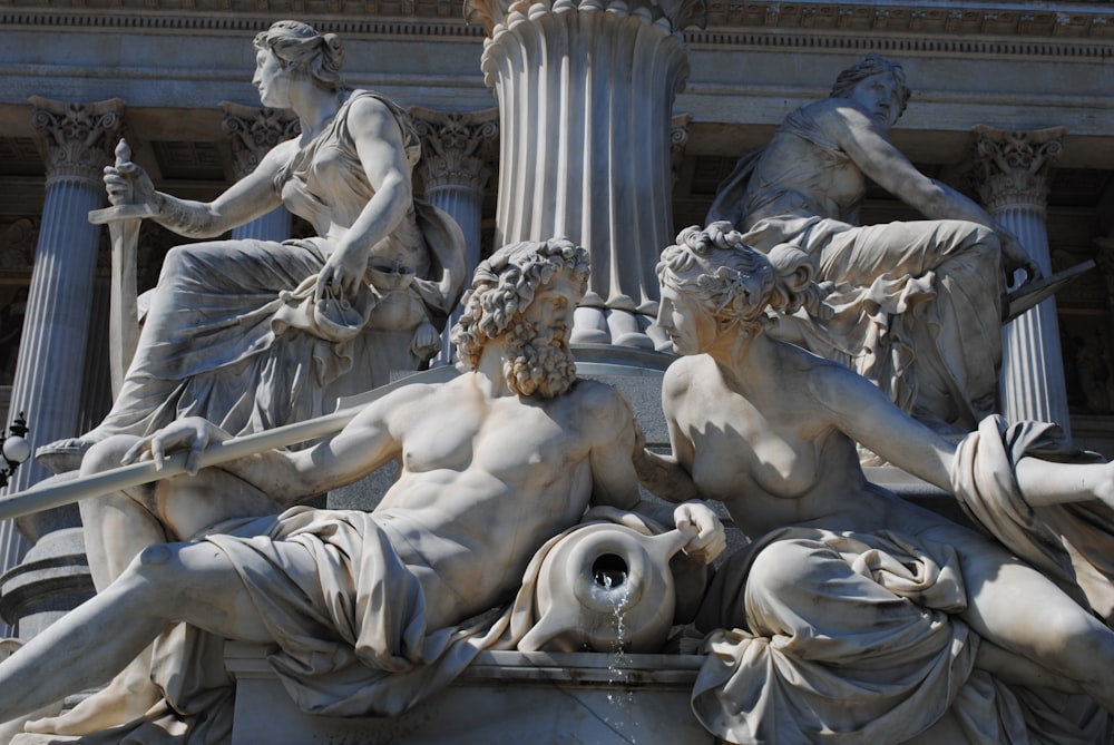 white concrete statue of man and woman