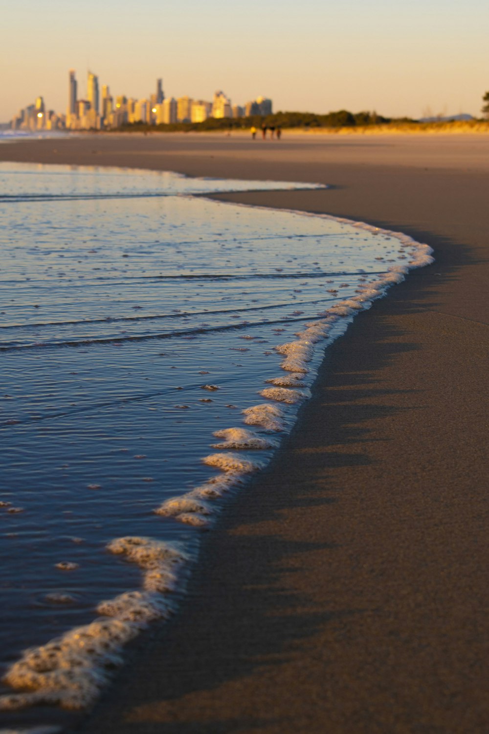 brown sand near body of water during daytime