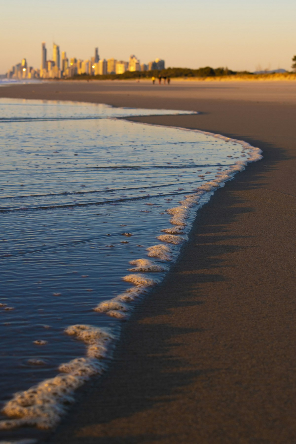 Broadbeach high-rises and Kurrawa beach with calm morning surf