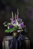 purple flowers in gray vase