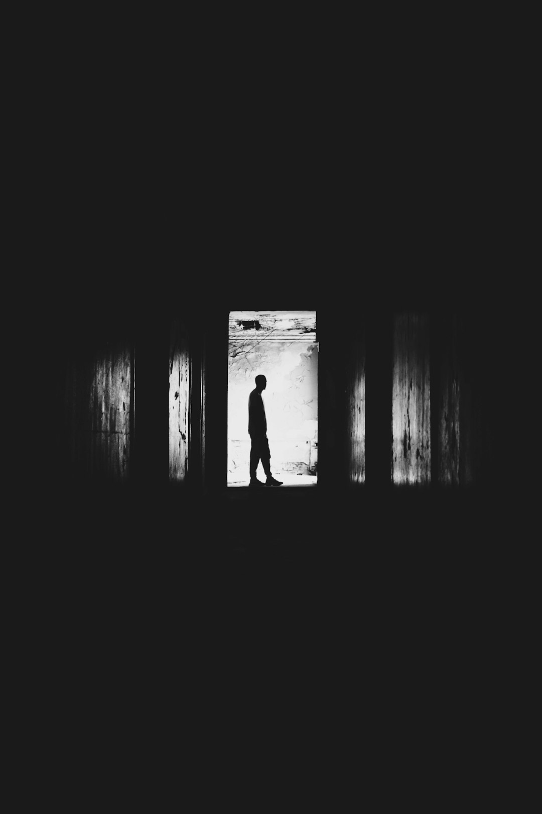 silhouette of man in dark room