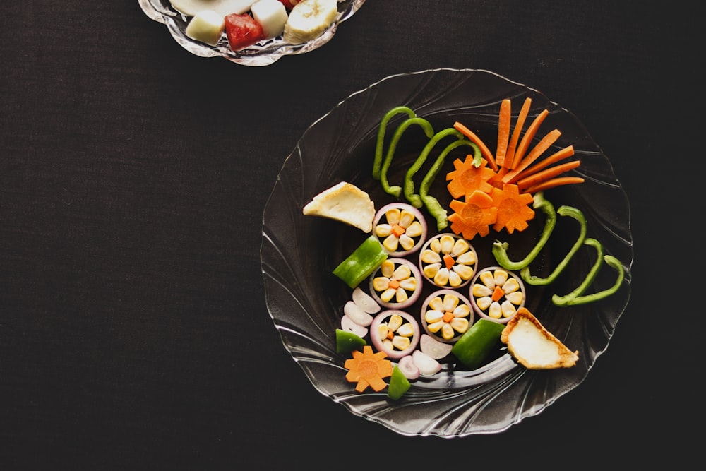 sliced fruits on black round plate