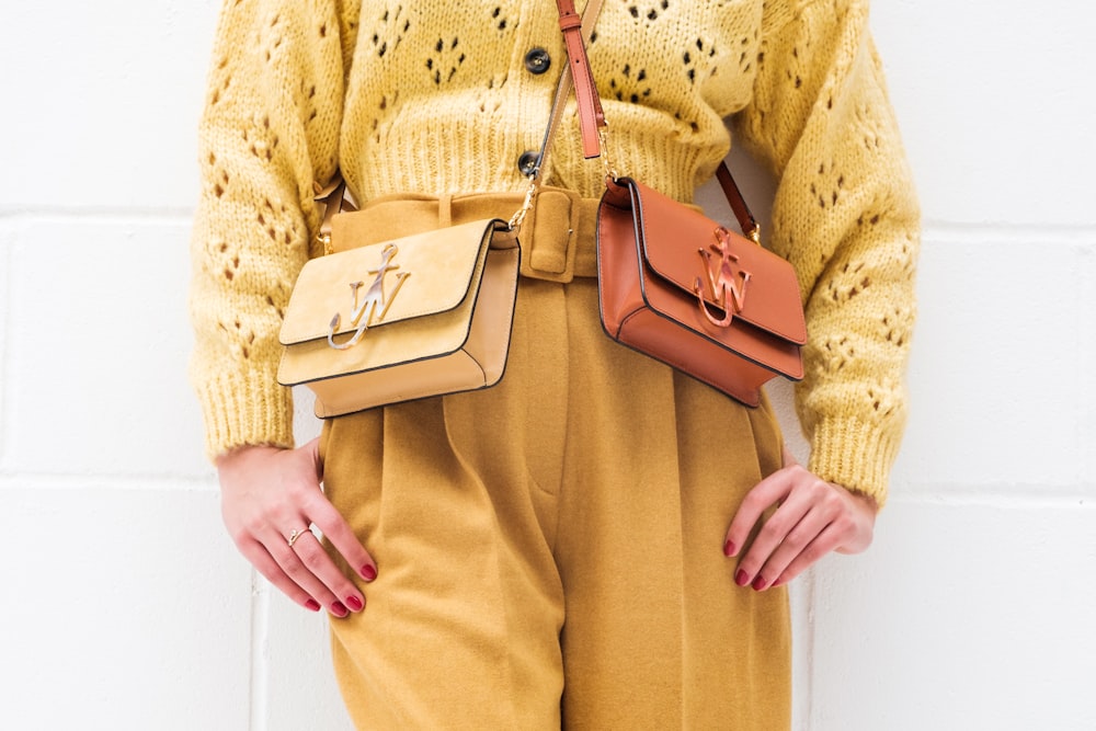 woman in brown leather sling bag