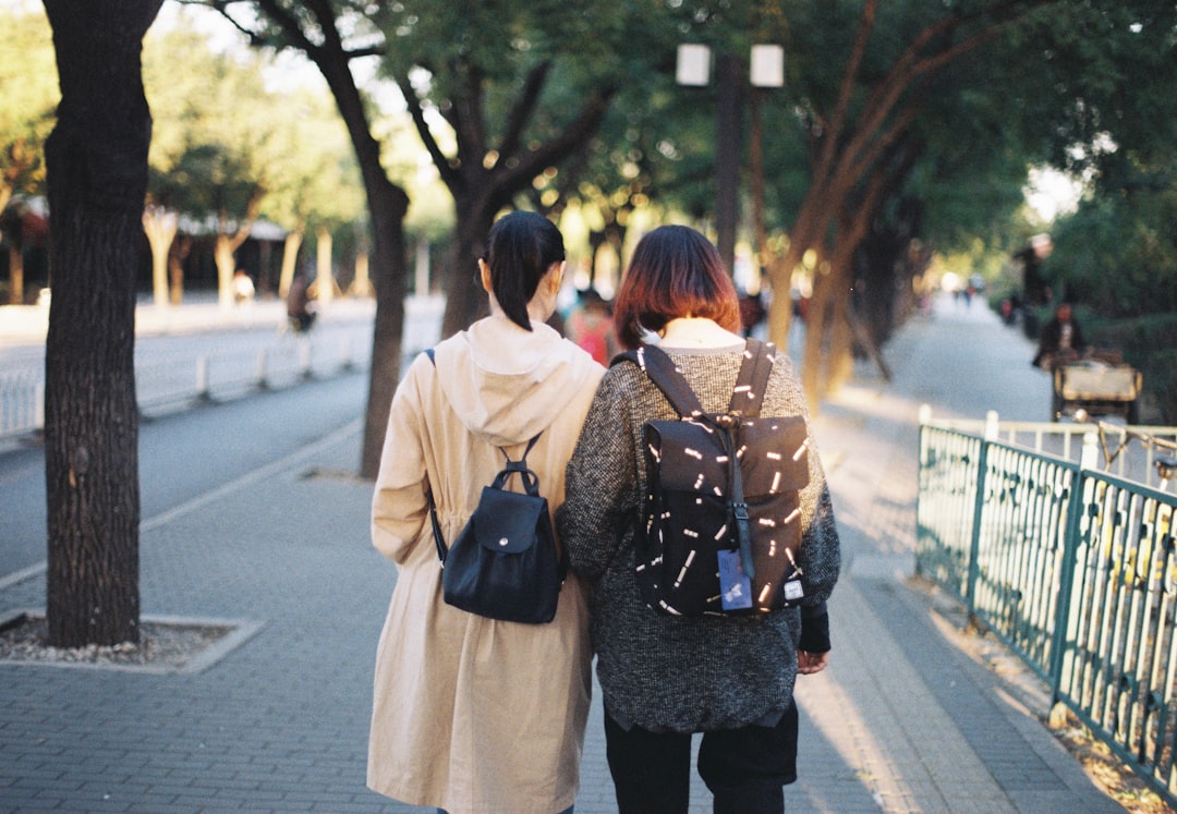 couple walking on the street during daytime