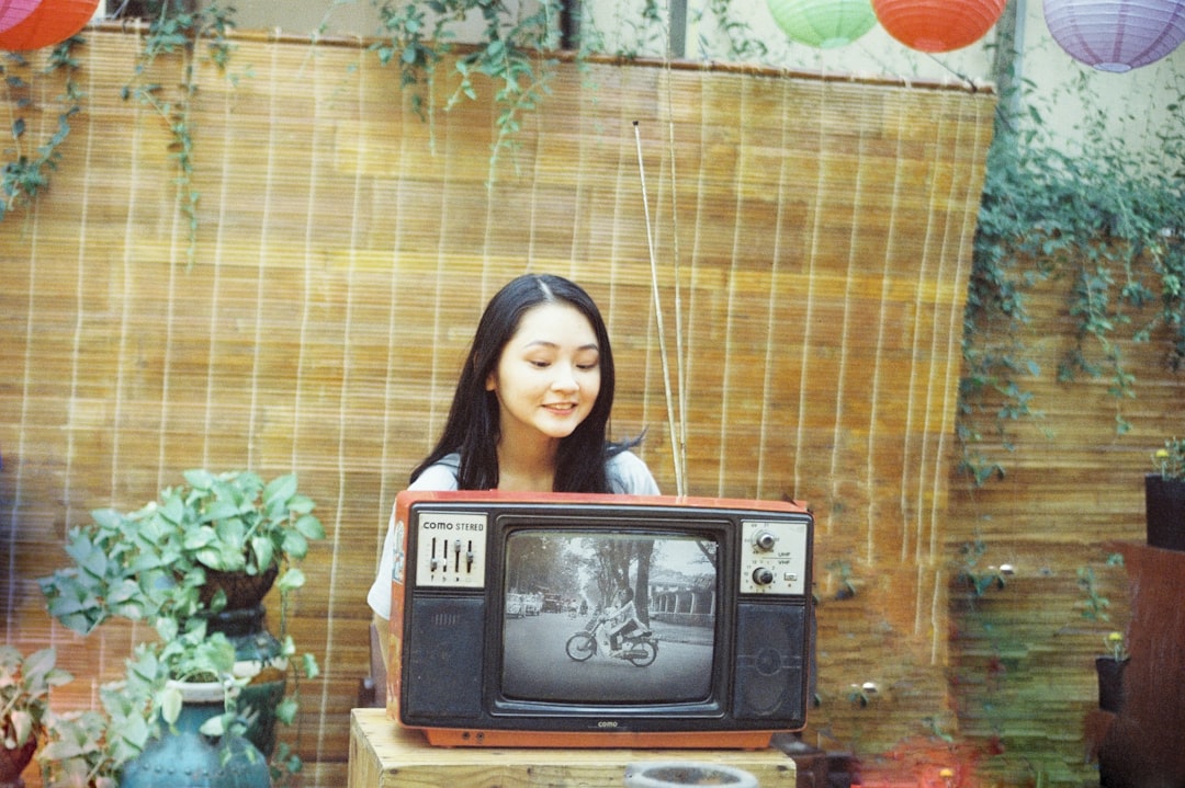 woman in black and white striped shirt standing in front of brown wooden table