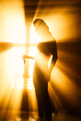 A mentor guiding a student, bathed in warm light reflecting the phoenix-inspired palette.