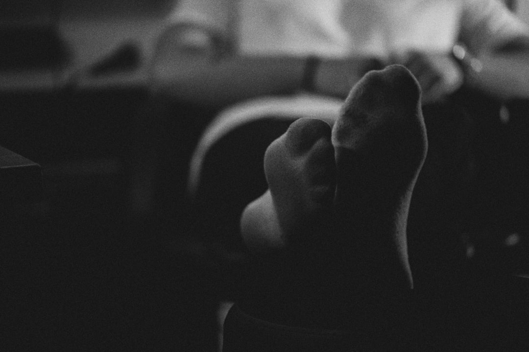 grayscale photo of persons hand