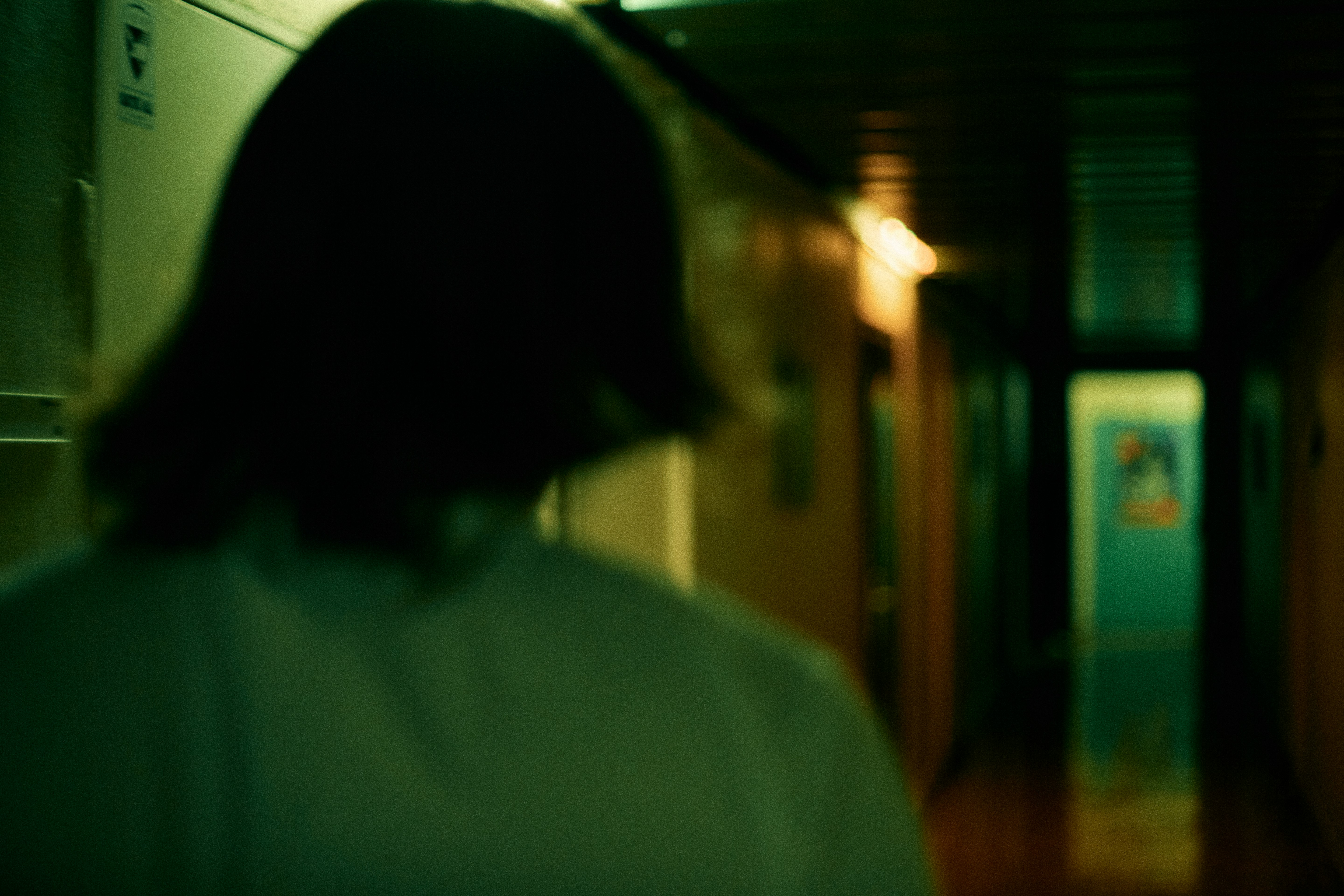 woman in white shirt standing near brown wooden door