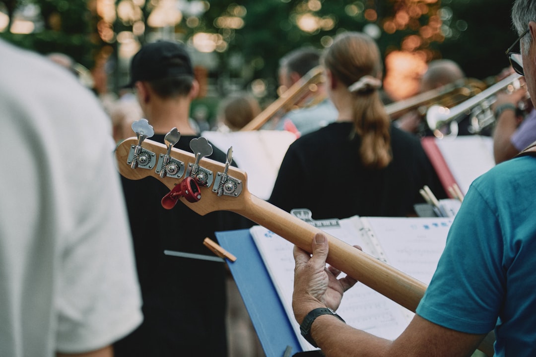 man in black t-shirt playing guitar