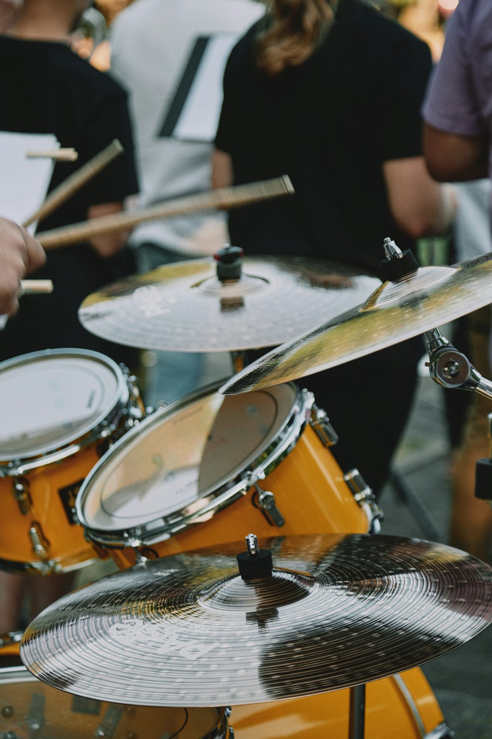 man in black jacket playing drum