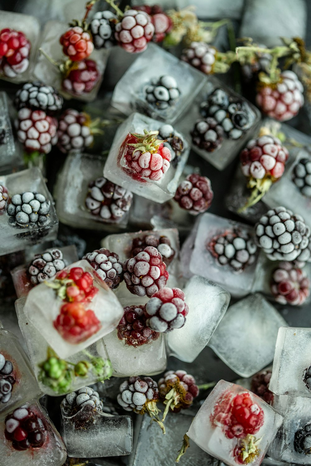 red and white round fruits on clear glass container
