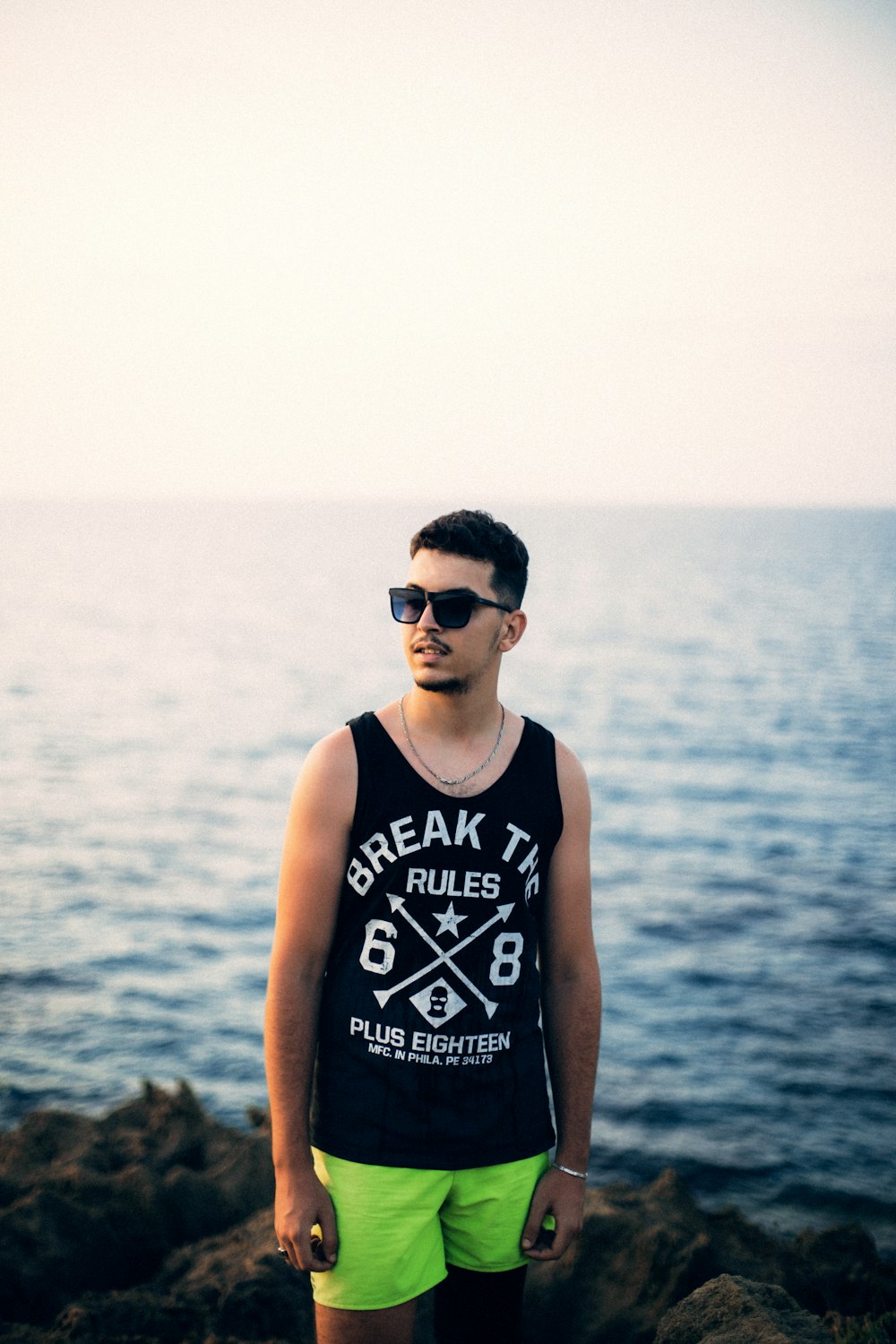 man in black tank top wearing black sunglasses