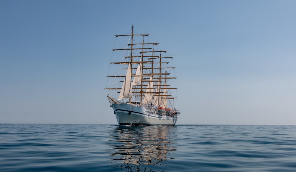 white sail boat on sea during daytime