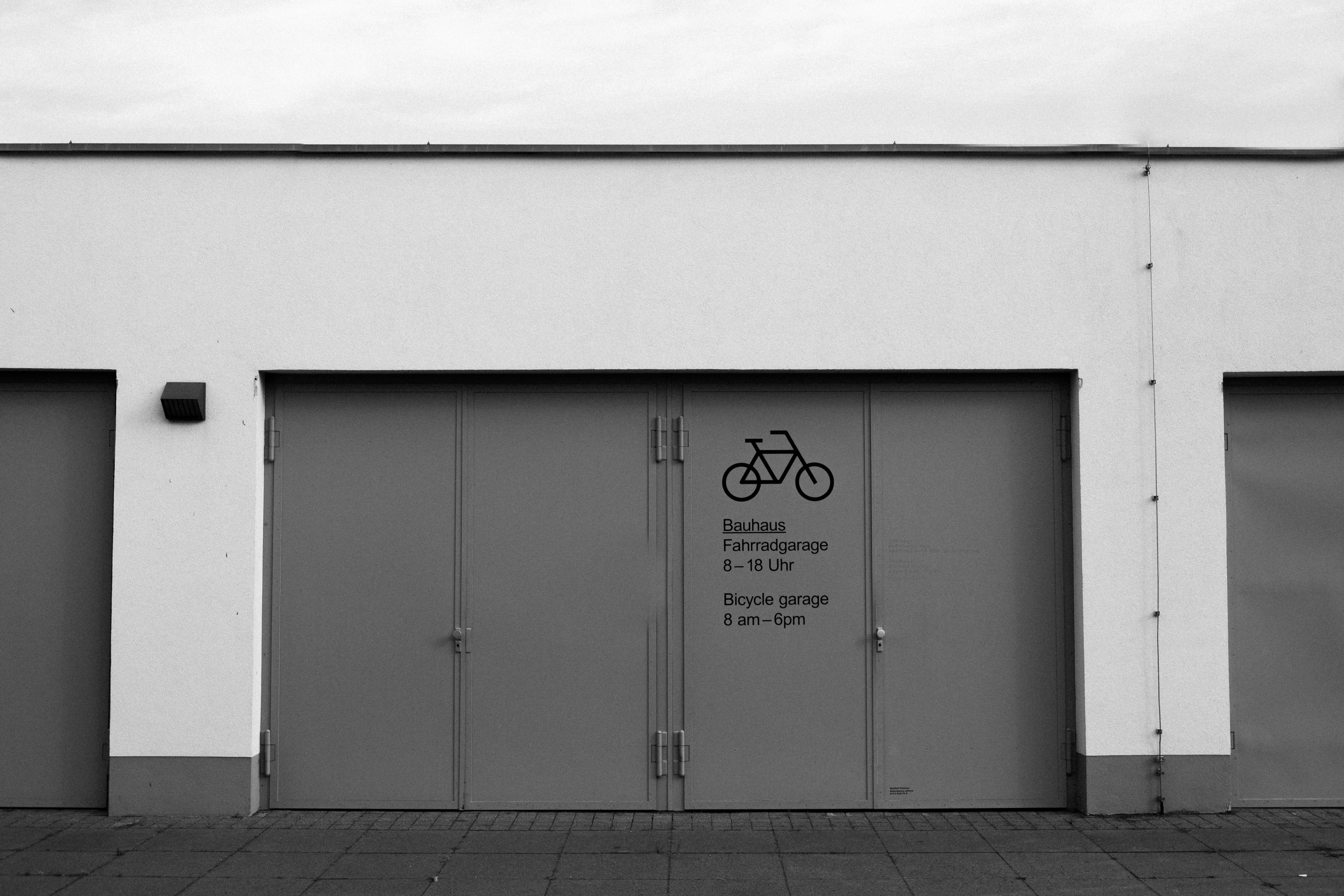 grayscale photo of white wooden door