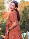 woman in red and white polka dot dress wearing black hat