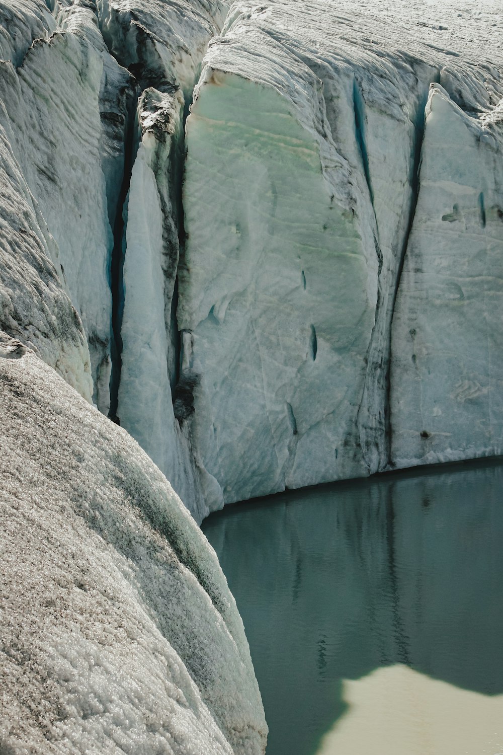 brown rock formation beside body of water during daytime