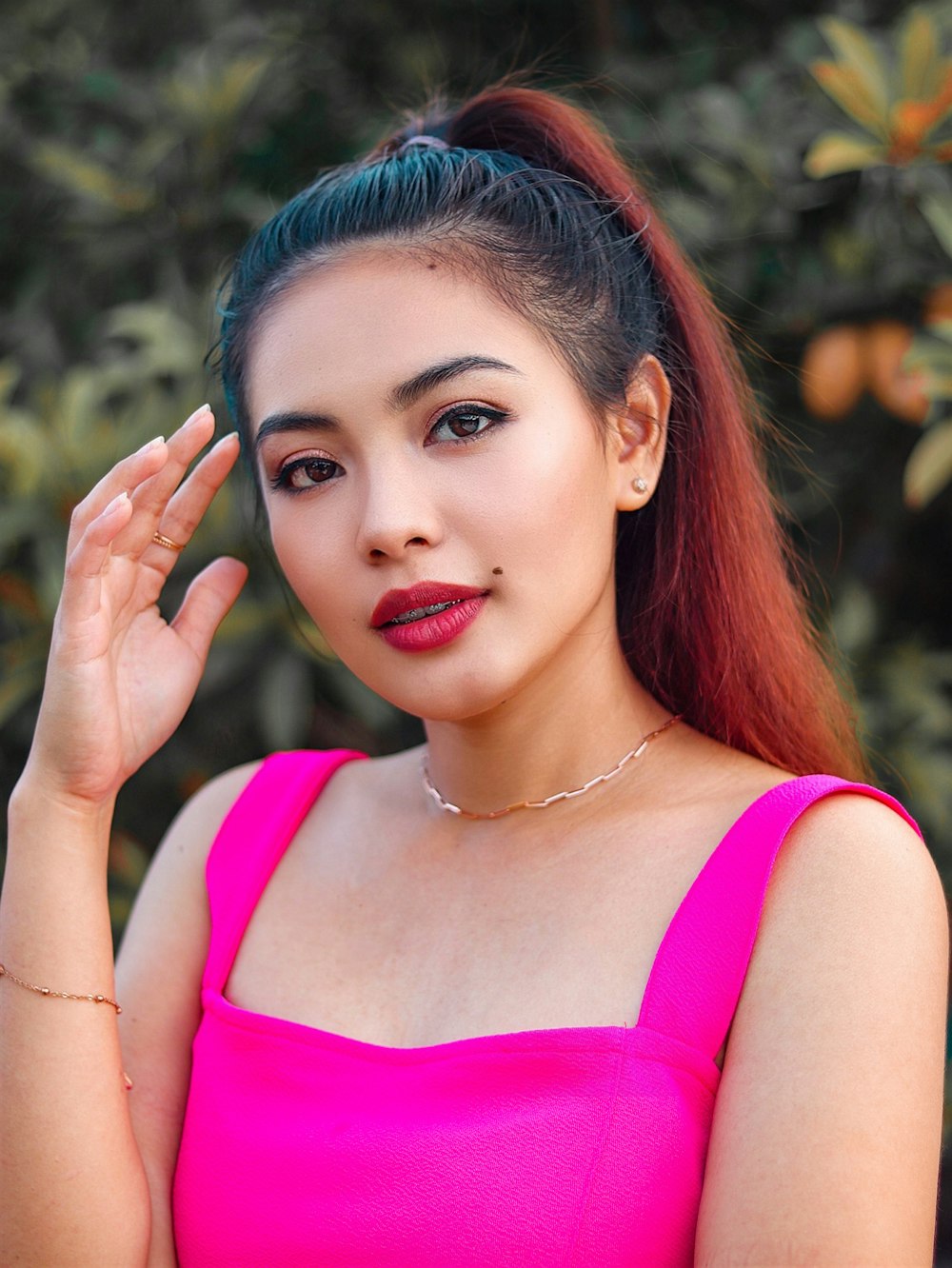 woman in pink tank top with red lipstick