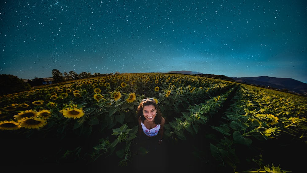 woman in sunflower field at dusk