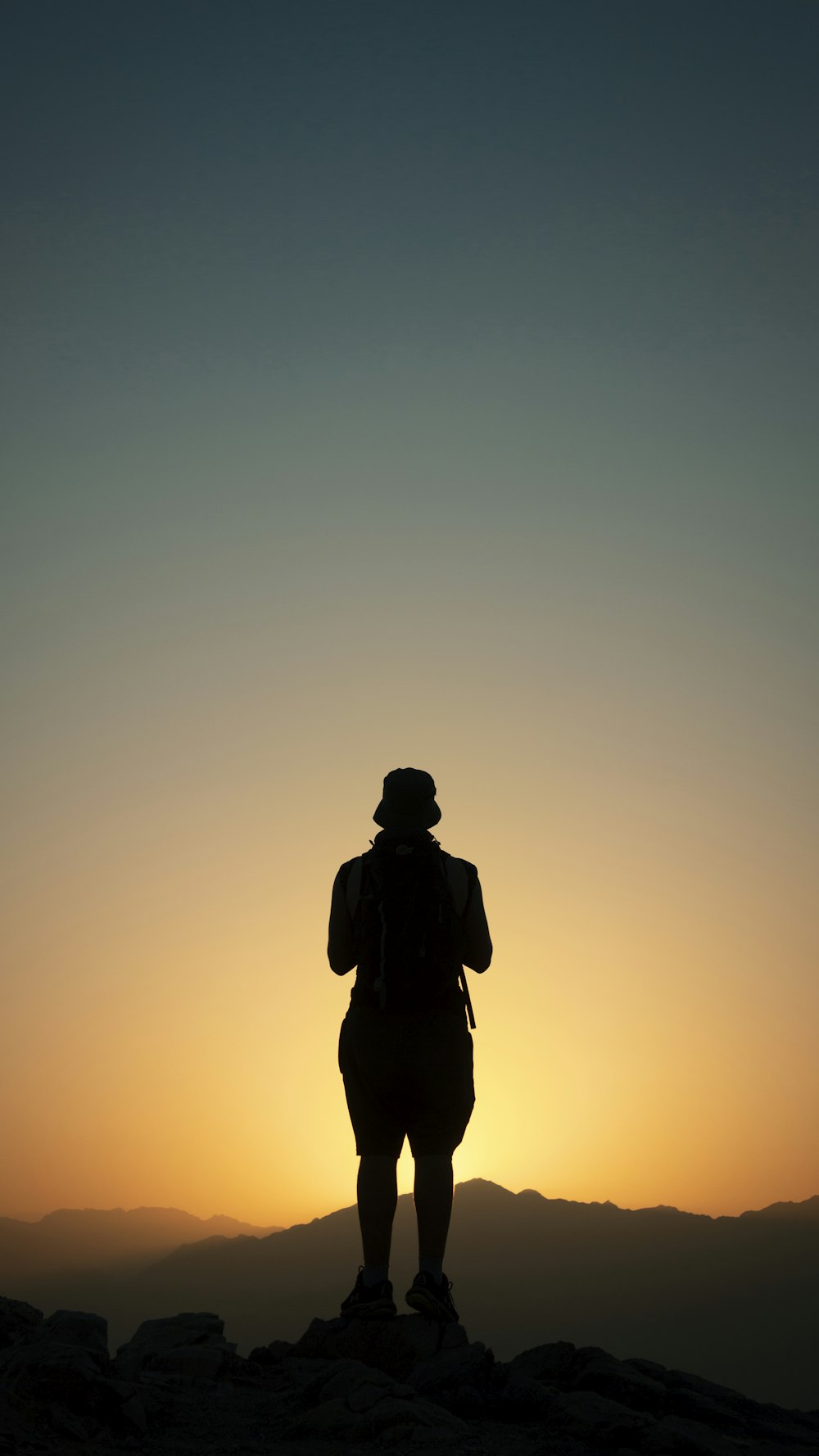 silhouette of man standing during sunset