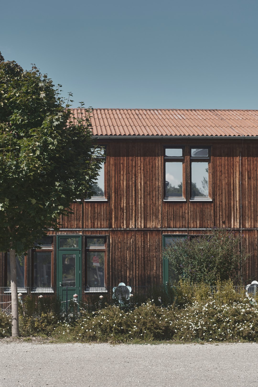 brown wooden house near green trees during daytime