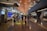 A modern airport terminal with high ceilings and long corridors. Information displays and signboards direct travelers towards gates C1-C29. People are moving with luggage, some checking flight information on the screens.