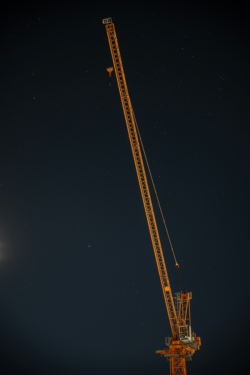 yellow and black crane under starry night