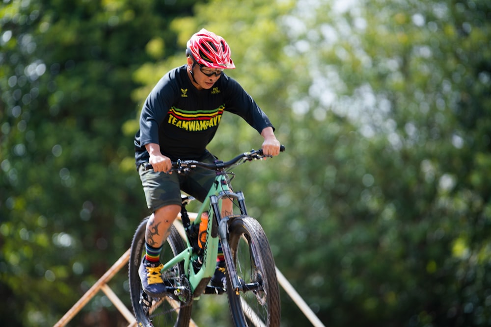 man in black jacket riding bicycle during daytime