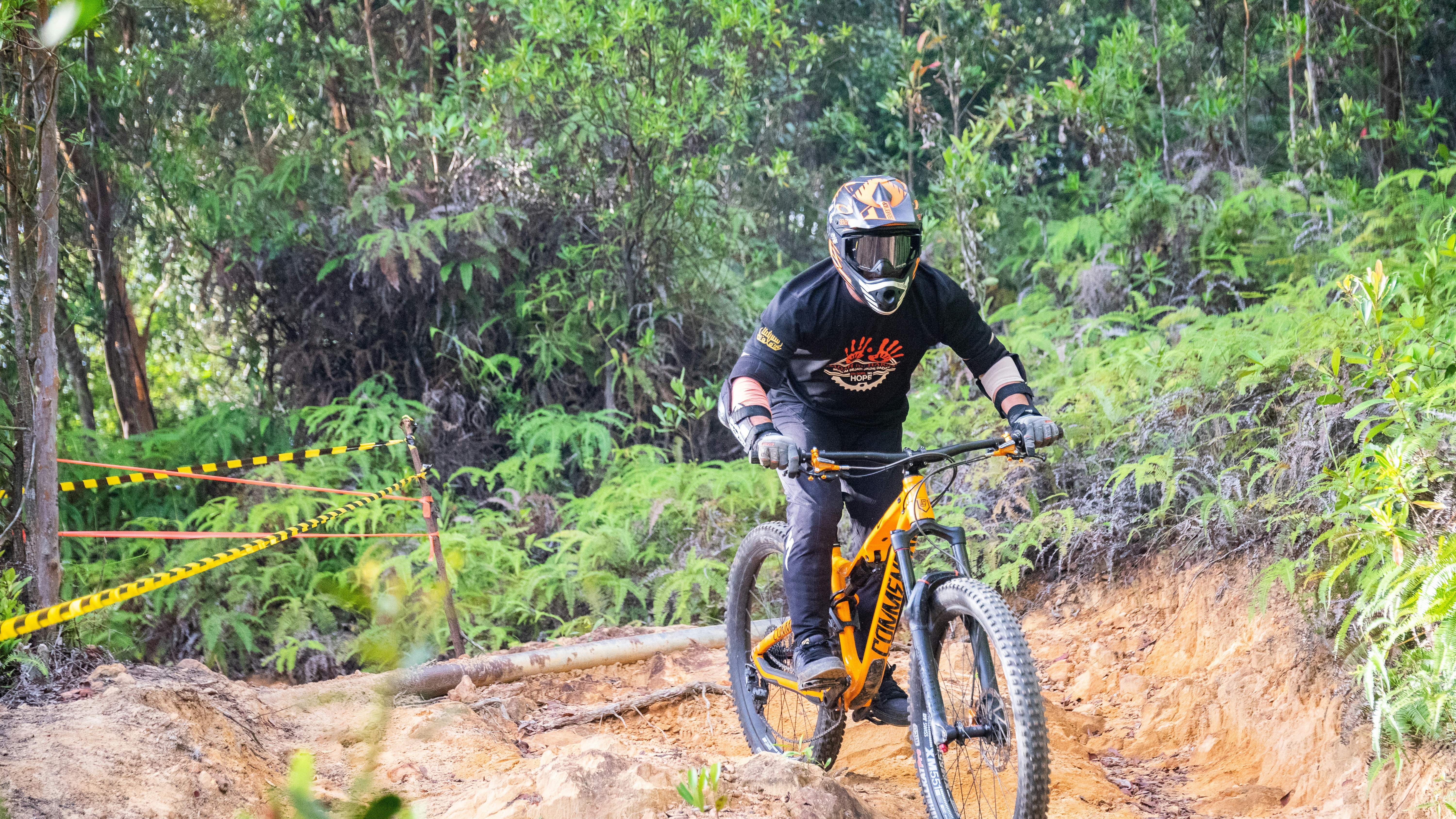 man in black helmet riding on black and yellow mountain bike