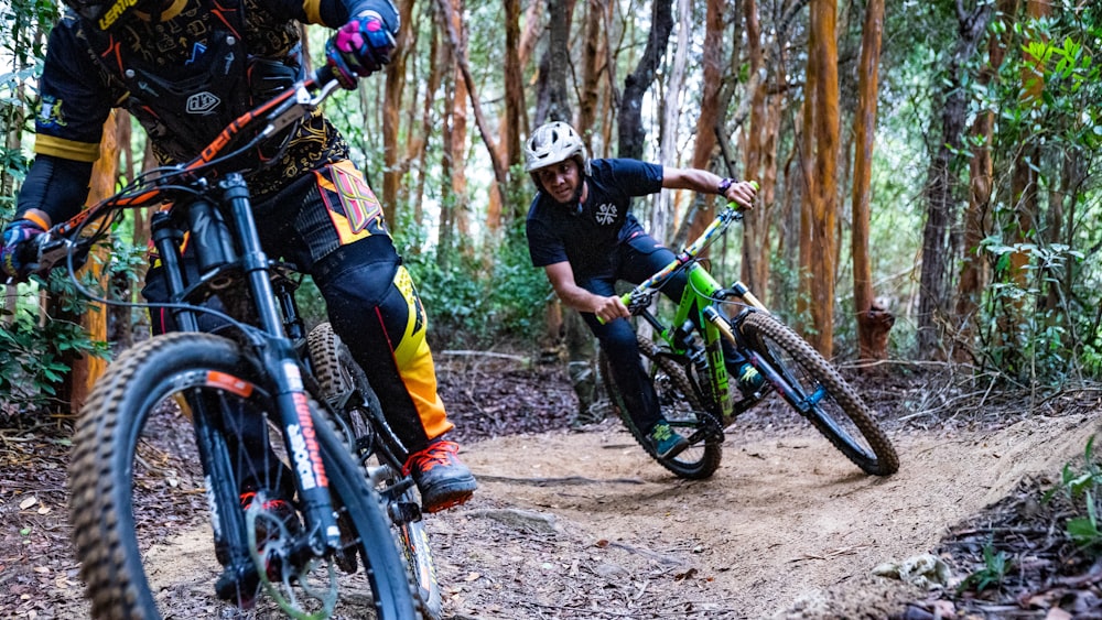 man in black and yellow shirt riding on mountain bike