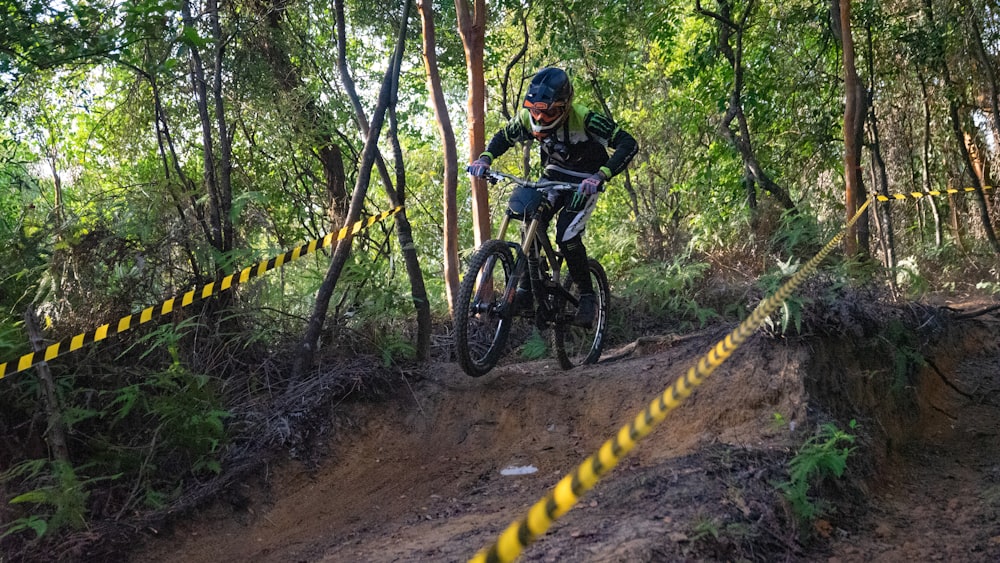 man in black jacket riding mountain bike