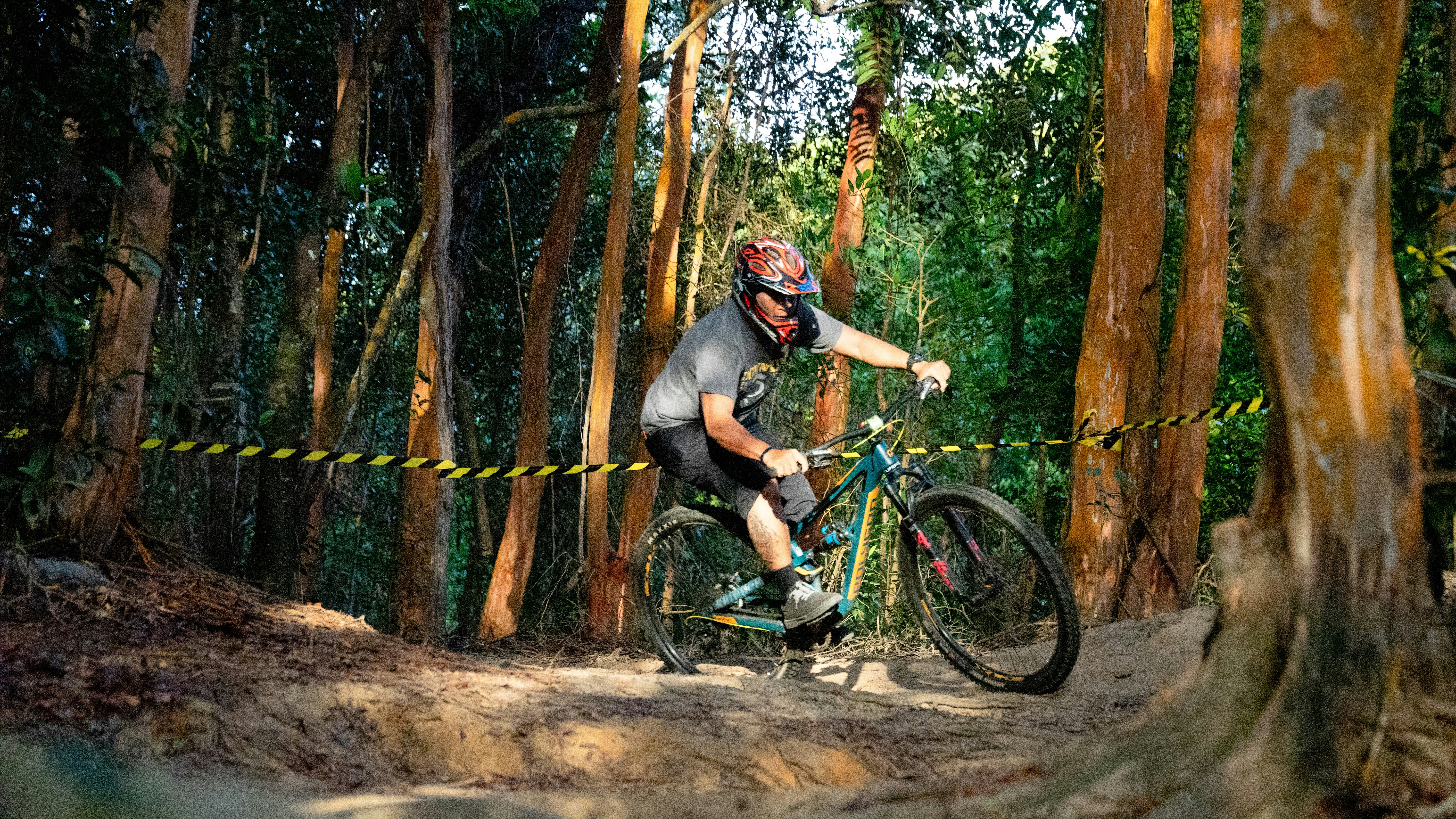 man in black helmet riding blue mountain bike