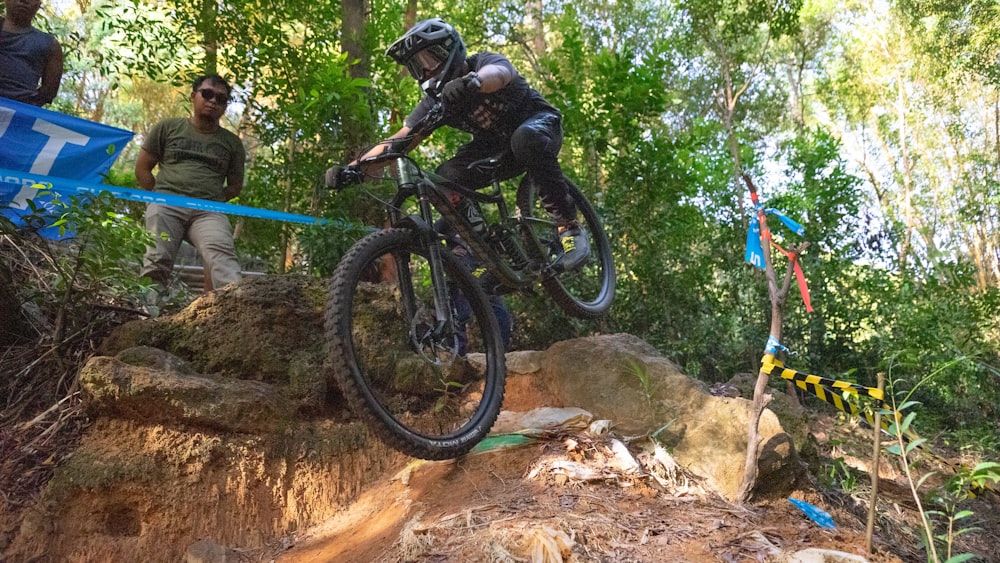 man in black helmet riding mountain bike