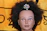 Close-up of a luxurious black and gold Belerys wig displayed on a sleek mannequin head.