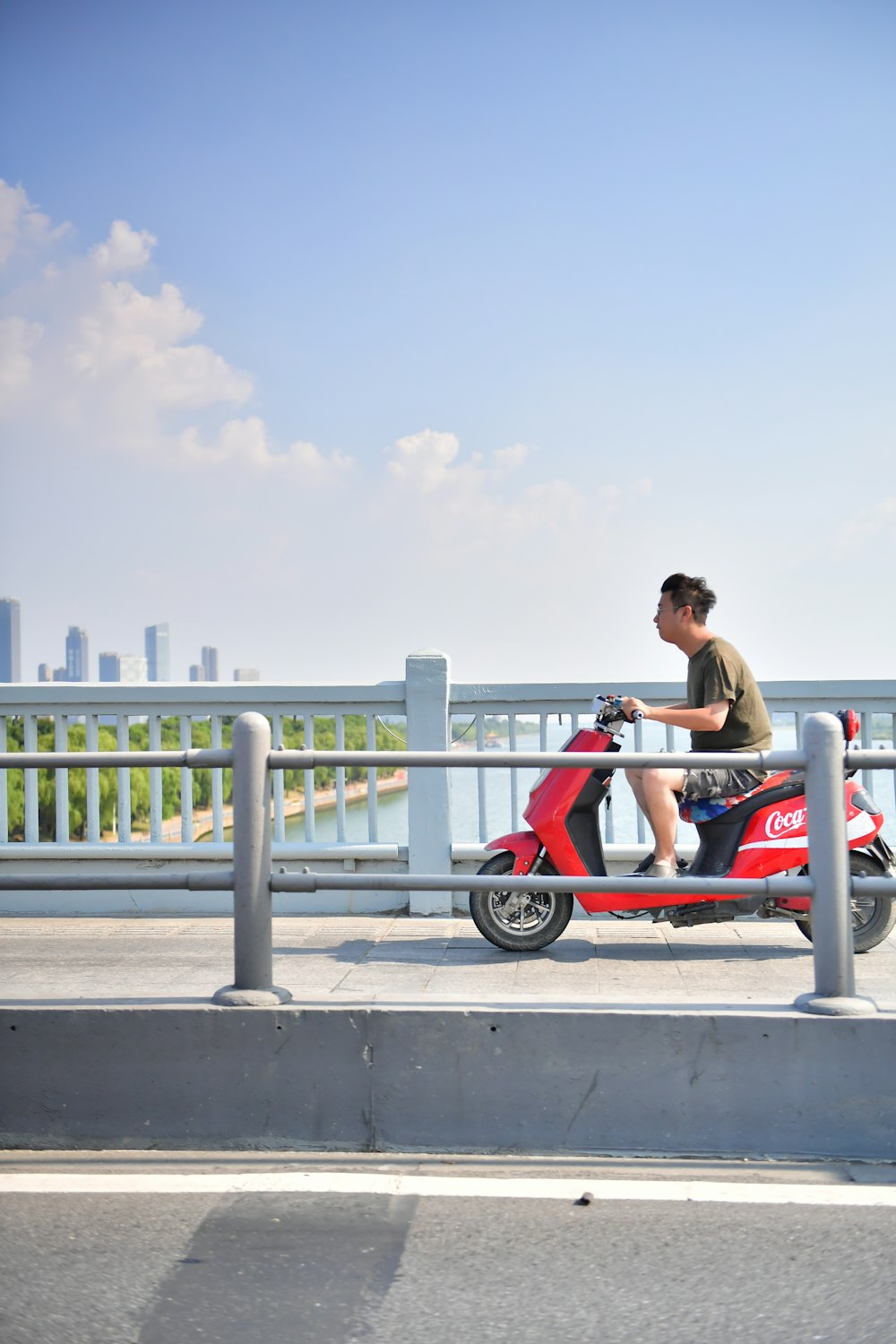woman in red tank top sitting on red and white bicycle during daytime